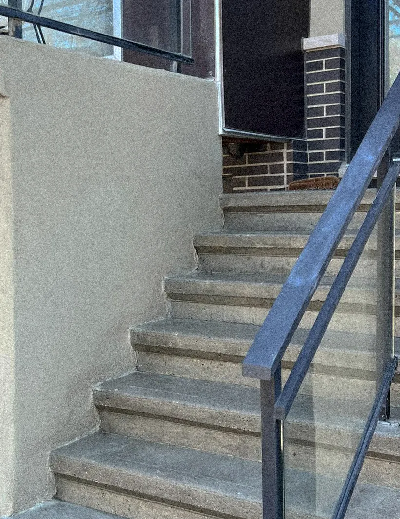 Parged stair side wall with crisp, straight cut-lines
